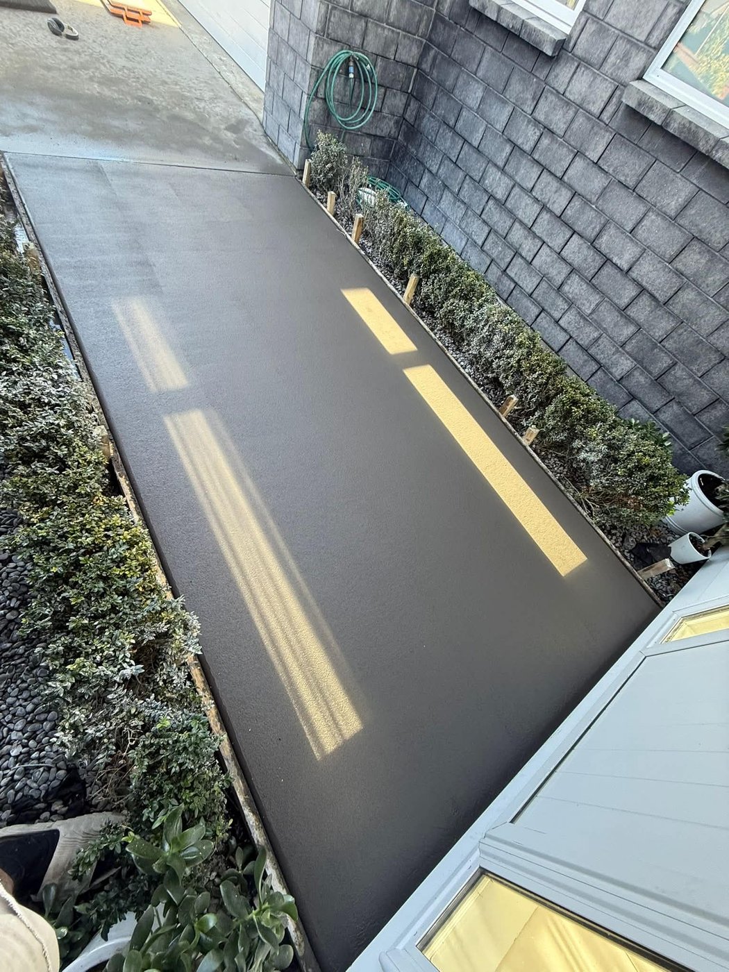 Curved concrete path with toned finish