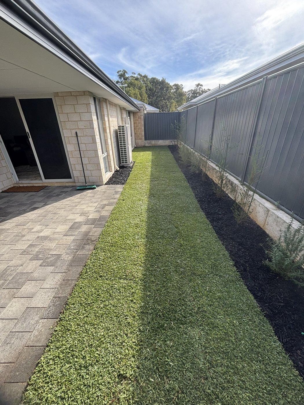 Paved and turfed side yard